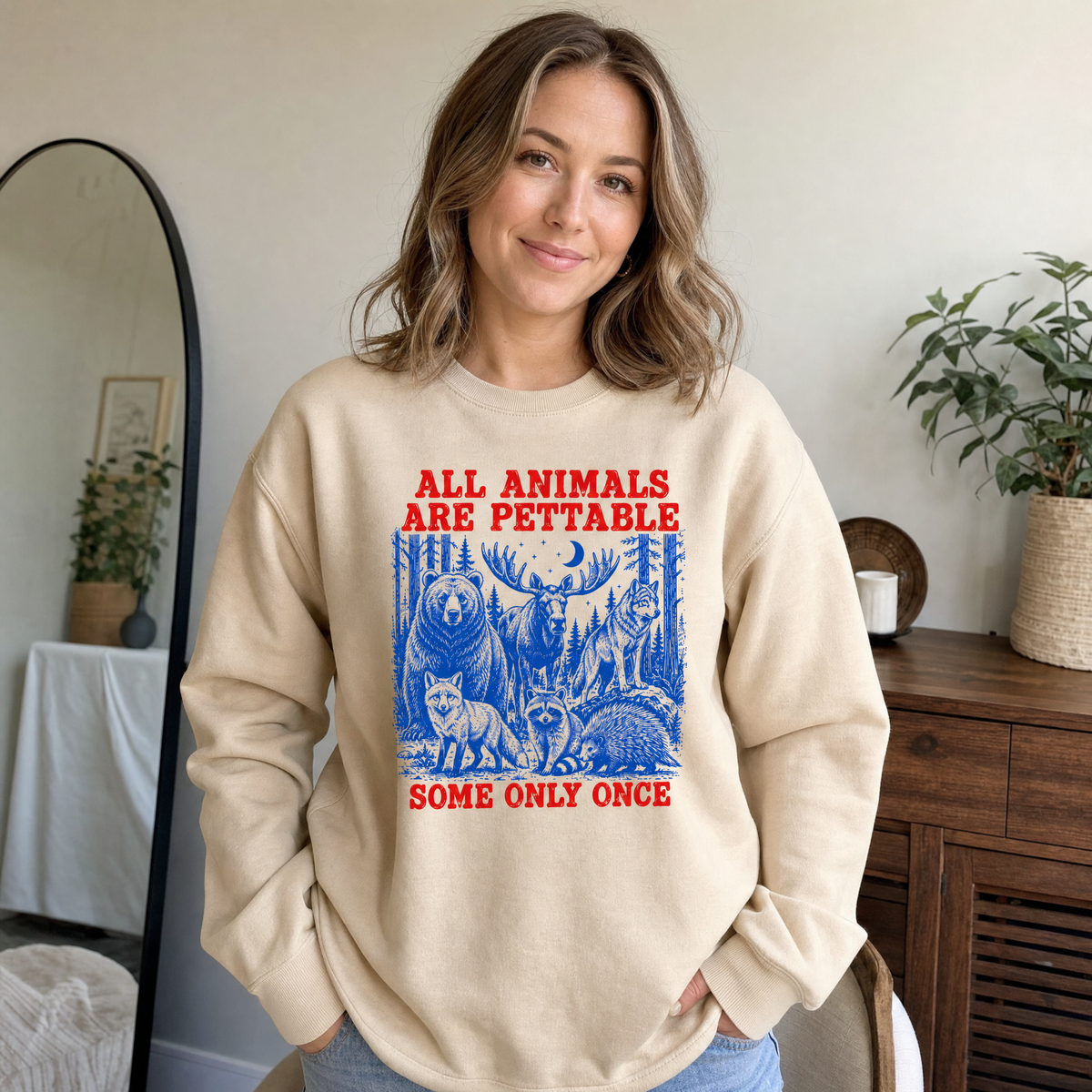 Model wearing the Pettable Animals sweatshirt in Sand
