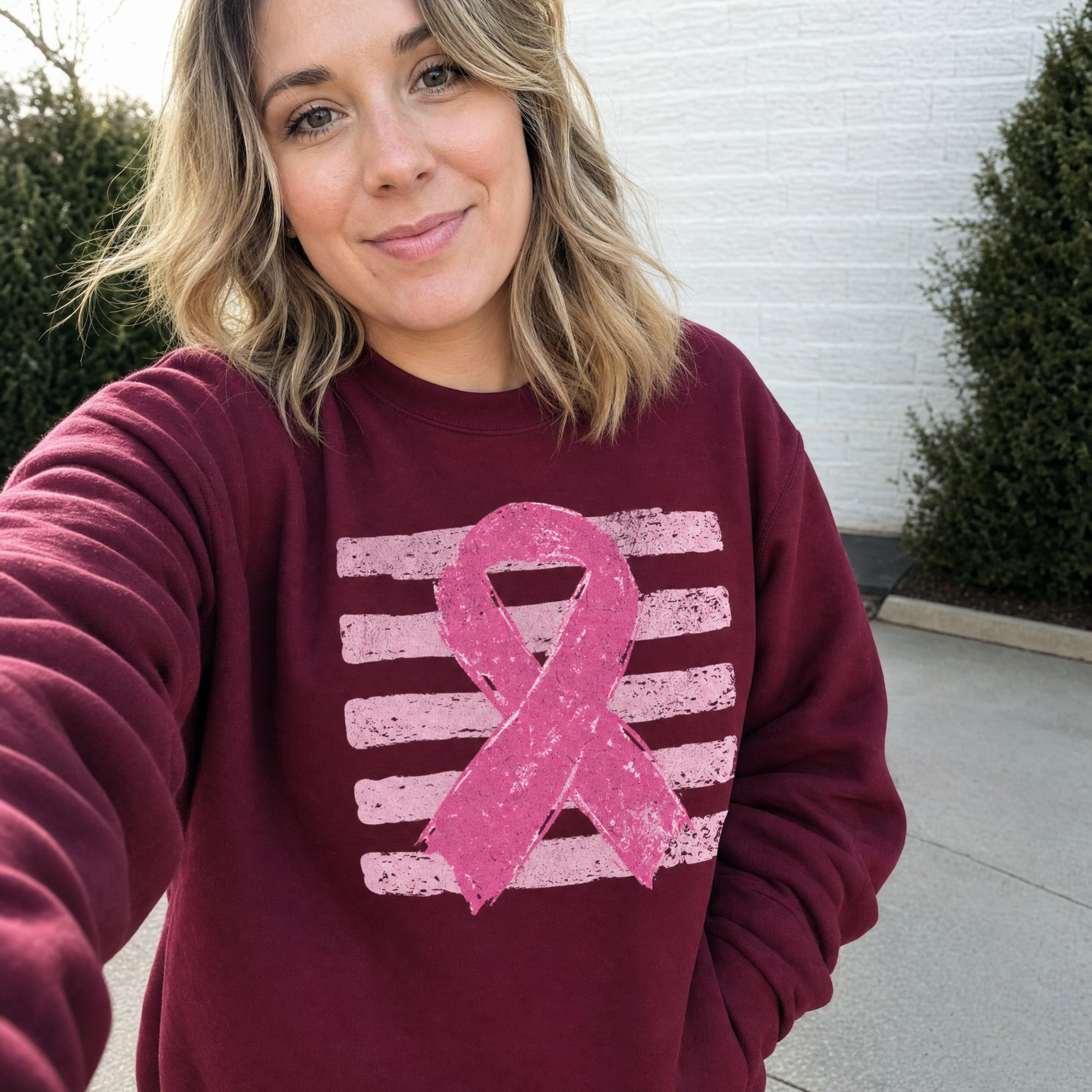 Model wearing the Pink Out sweatshirt in Maroon