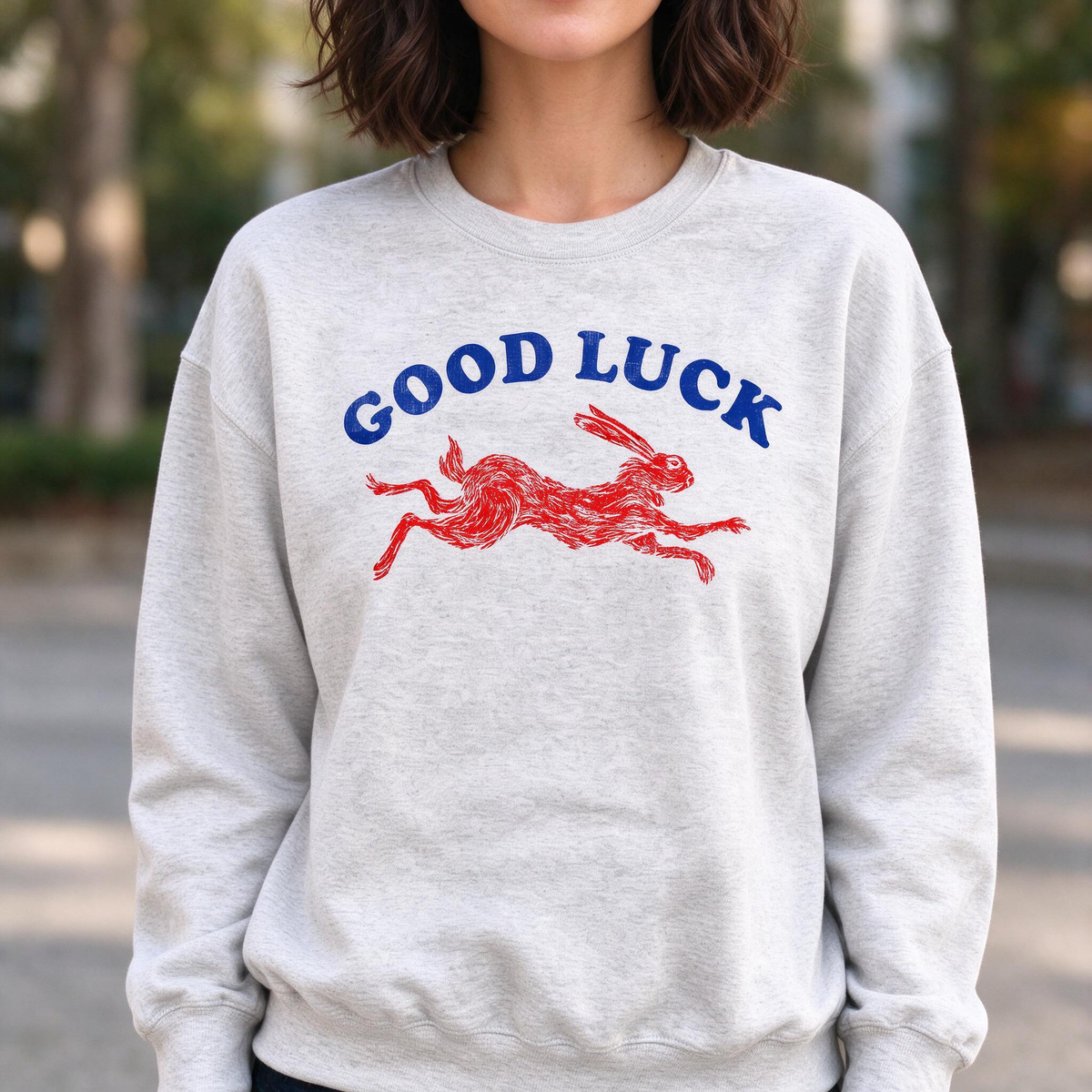 Model wearing the Running Rabbit sweatshirt in Ash, lifestyle image 1