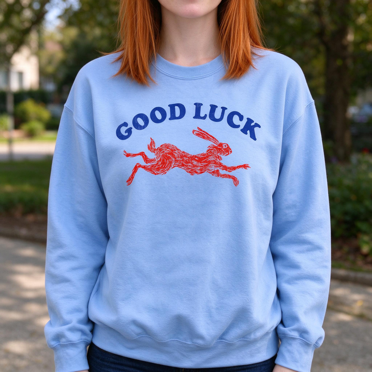Model wearing the Running Rabbit sweatshirt in Carolina Blue
