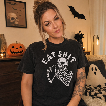Model wearing the Skeleton Flipping Off comfort colors tee in Black, lifestyle image 1