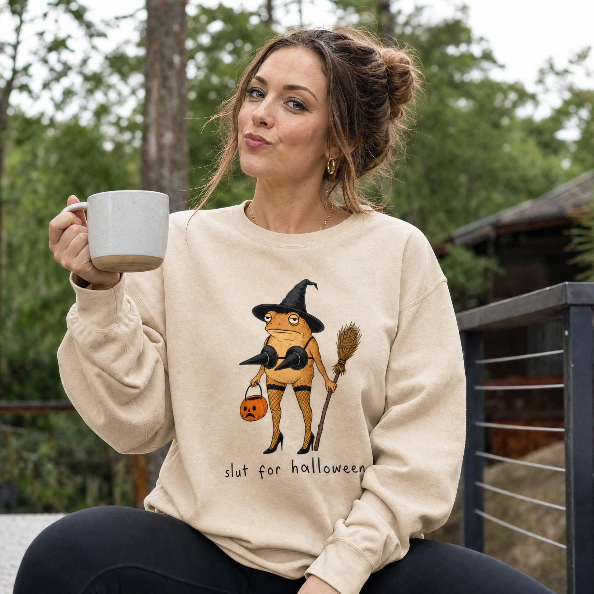 Model wearing the Slut For Halloween sweatshirt in Sand, lifestyle image 1