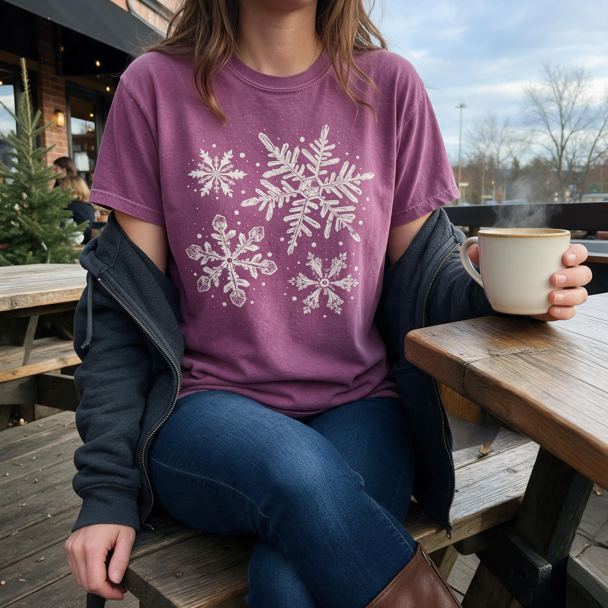Model wearing the Snowflakes comfort colors tee in Berry