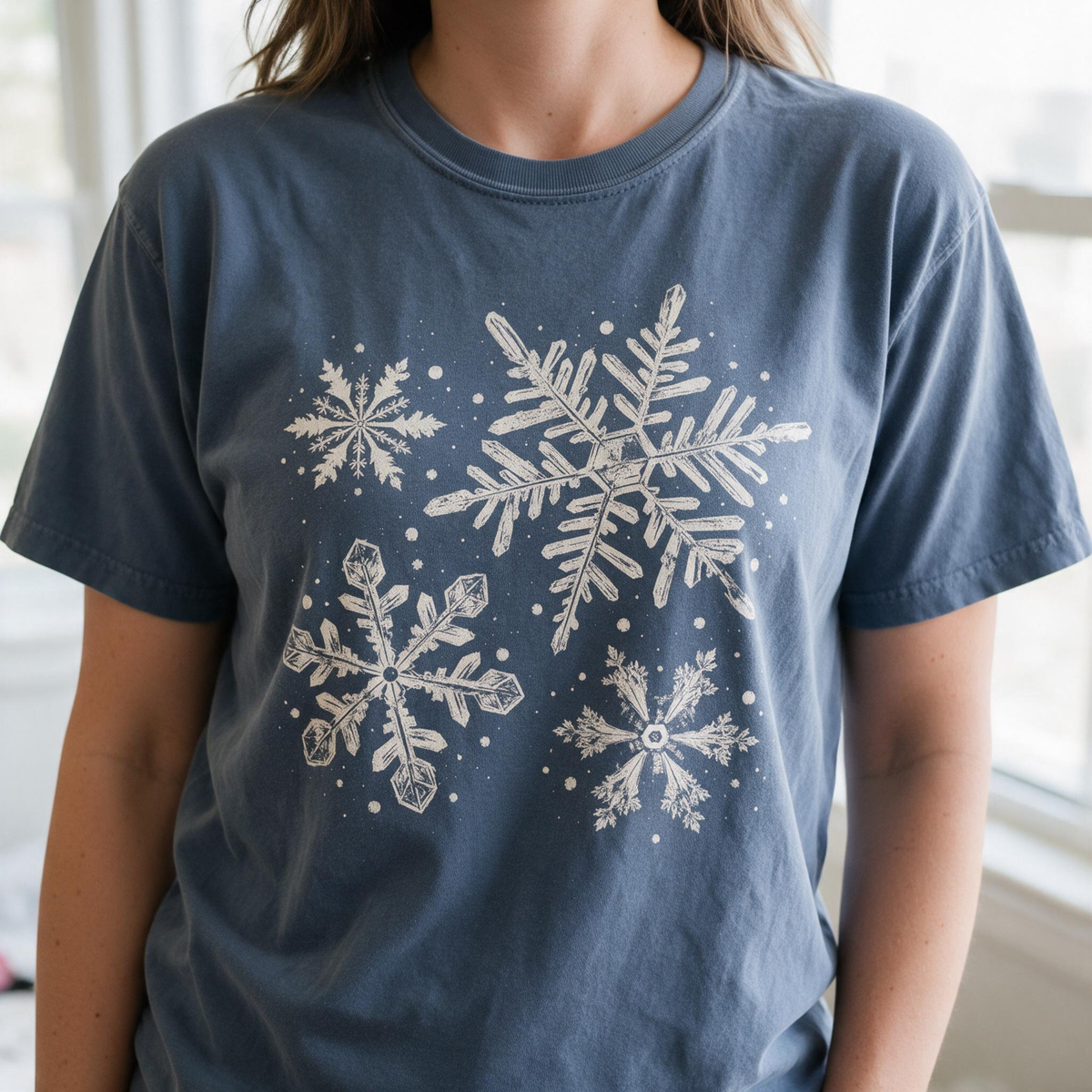 Model wearing the Snowflakes comfort colors tee in Denim