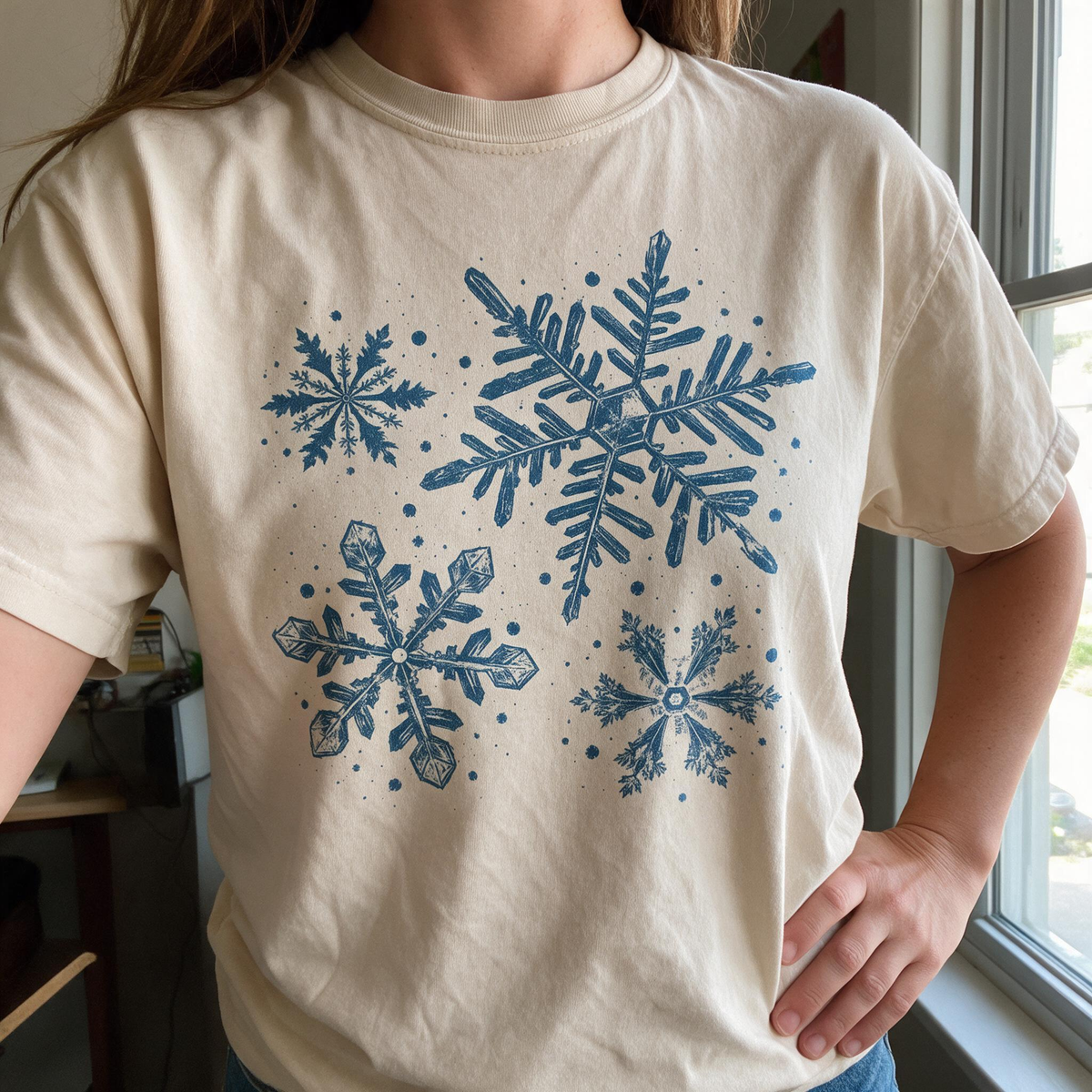 Model wearing the Snowflakes comfort colors tee in Ivory