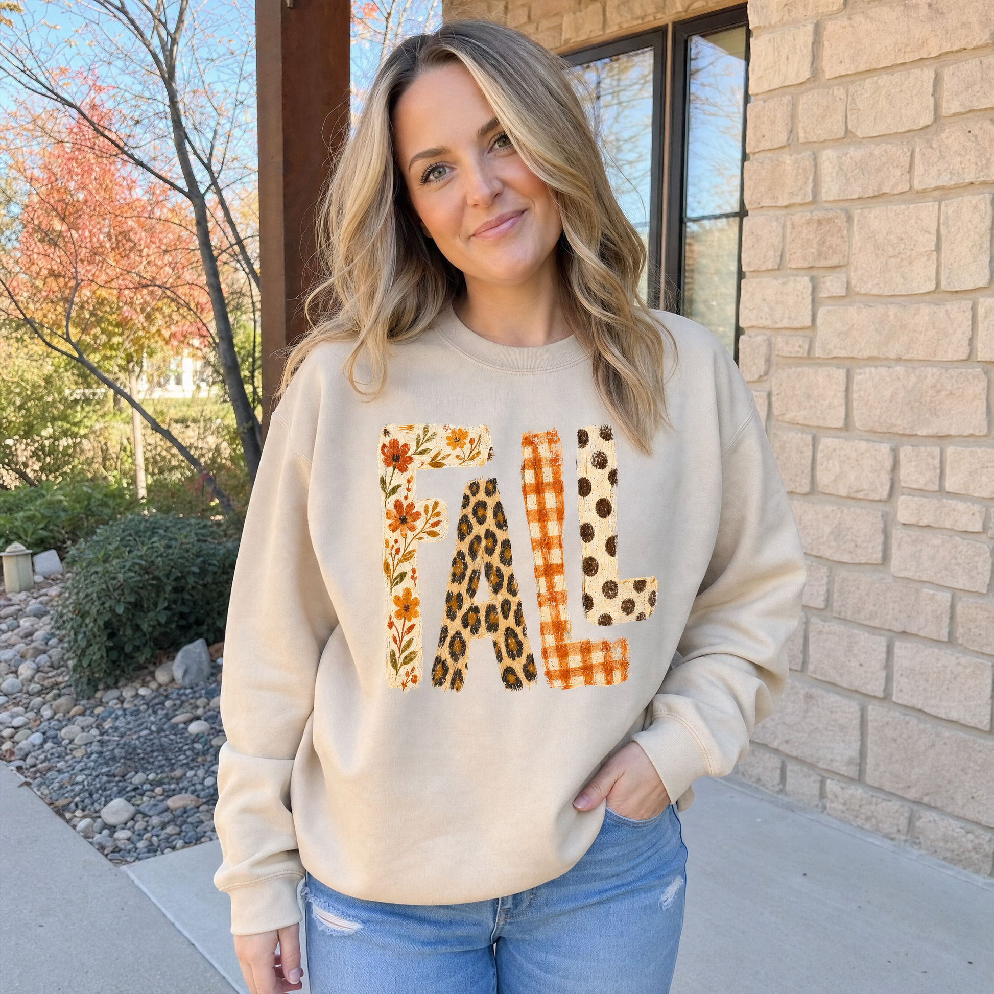 Model wearing the Fall Pattern Letters sweatshirt in Sand